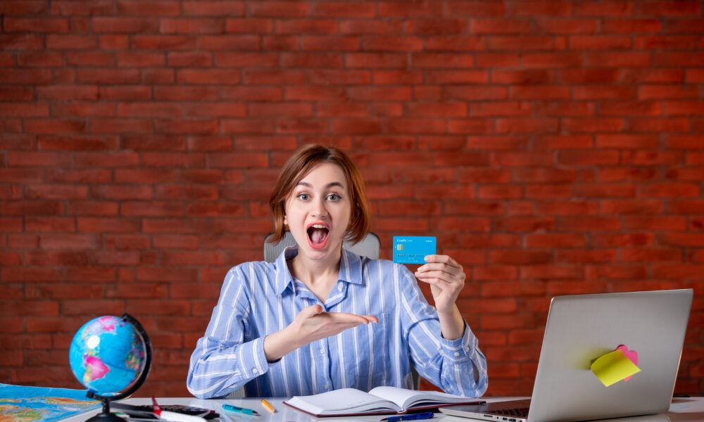 front-view-travel-agent-her-working-place-holding-credit-card-map-indoors-manager-worker-service-operator-world-money-agency-document-1000x600-2