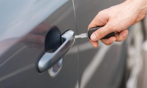 Transportation,And,Ownership,Concept,-,Man,With,Car,Key,Outside