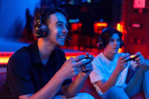 two-teen-friends-headphones-are-playing-game-console-using-gamepads-smiling_1268-25912-5