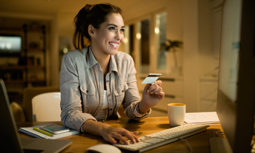 young-happy-woman-using-credit-card-online-shopping-evening-home-1000x600-1